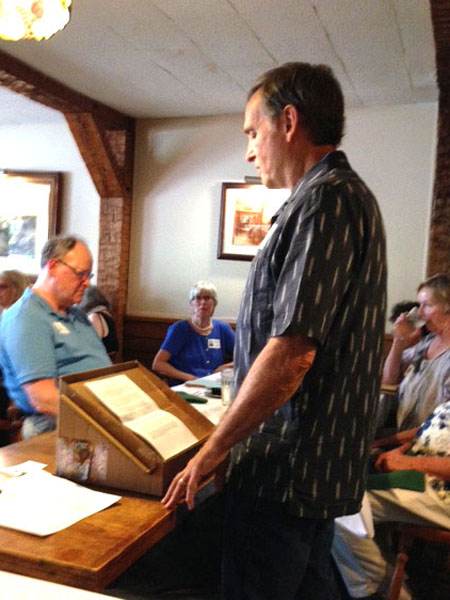 Photo of John reading his long speech